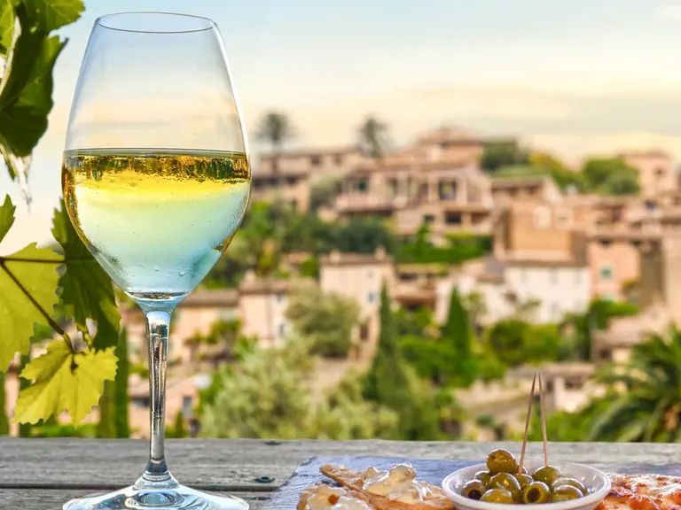 Wie die Landschaft, so das Essen: In Spanien sind Kulinarik und Umgebung eng miteinander verwoben. Ein Weinglas mit Blick auf die Landschaft, Genuss und Spezialitäten in Spanien